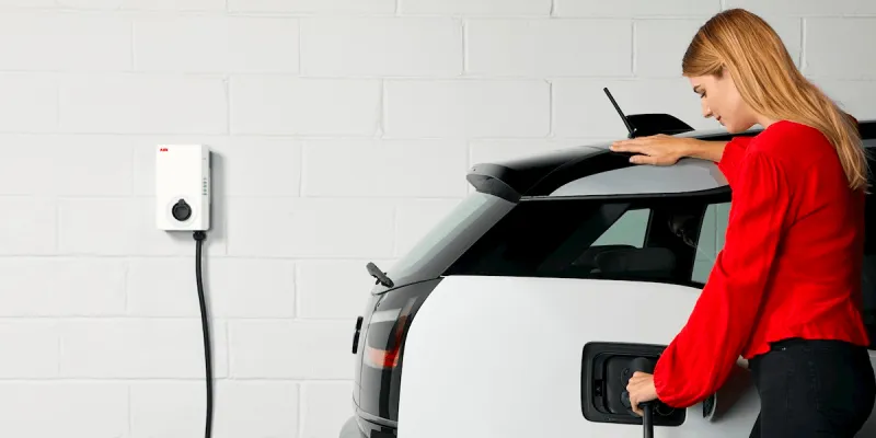 lady home charing her electrical vehicle